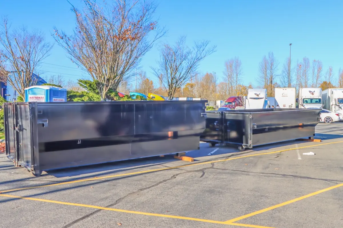 Professional dumpster rental service with roll-off container on residential driveway in Metuchen